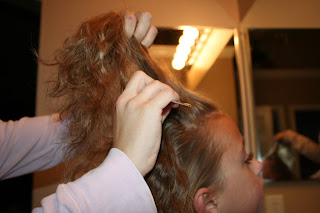 Young girl's 2nd Day Curls from Double-French Braids being styled