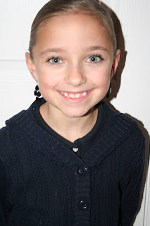 Portrait view of young girl modeling "bundled braids" hairstyle