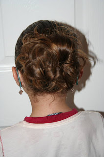 Back view of young girl modeling "Hair Twists into Messy Buns" hairstyle 