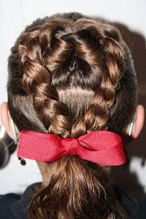 Back view of Young girl modeling "Flip Braided Heart" hairstyle