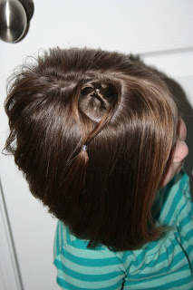 Top view of young girl modeling "teen heart" hairstyle 4