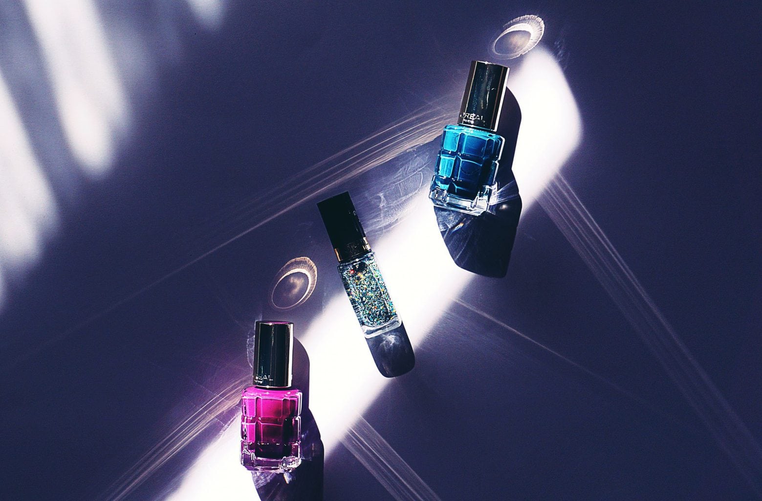 At home manicure tips: 3 nail polishes on table light shining on them
source: Suzy Hazelwood from Pexels