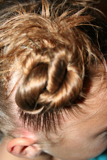 Side view of young girl modeling "4 Messy-Pigtail Twists" hairstyle