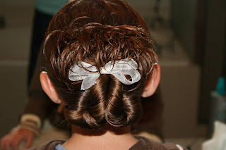 Back view of young girl modeling "Pretzel-Twist Messy Bun"