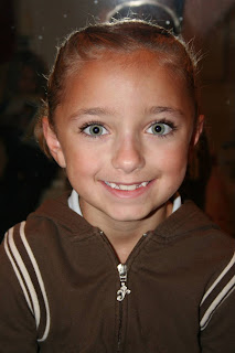 Portrait of young girl modeling "Double-French Braids w/Messy Flips" hairstyle