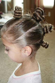 Side view of young girl modeling "The Bun-Hawk" hairstyle