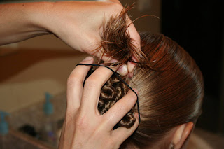 Young girl's hair being styled in to "Ponytail Of Twists" hairstyle