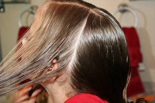 Young girl's hair being styled into "Triple Twists and Messy Buns"