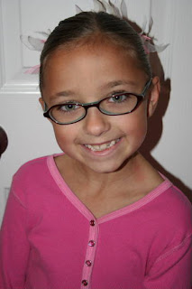 Portrait of young girl's hair modeling "Triple-Twist Ponytail' hairstyle