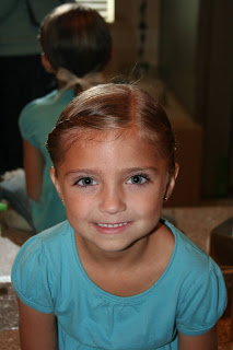 Portrait of young girl modeling hair styled into “Double-twist" ponytail