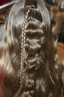 Back view of young girl's hair being styled into "Beachy Combo" hairstyle