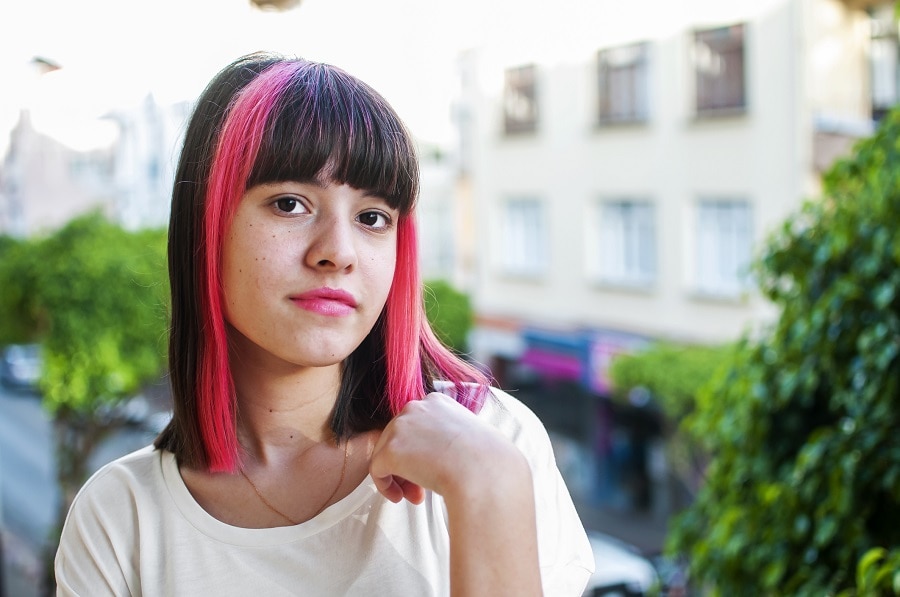 medium bob with bangs and dark pink highlights