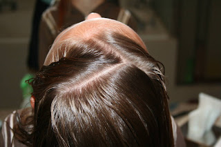 Top view of girl's hair being styled into "Zig-Zag Part"